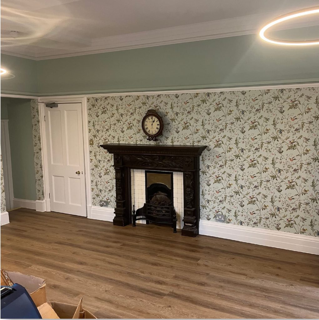 a room with a fireplace and a wood floor