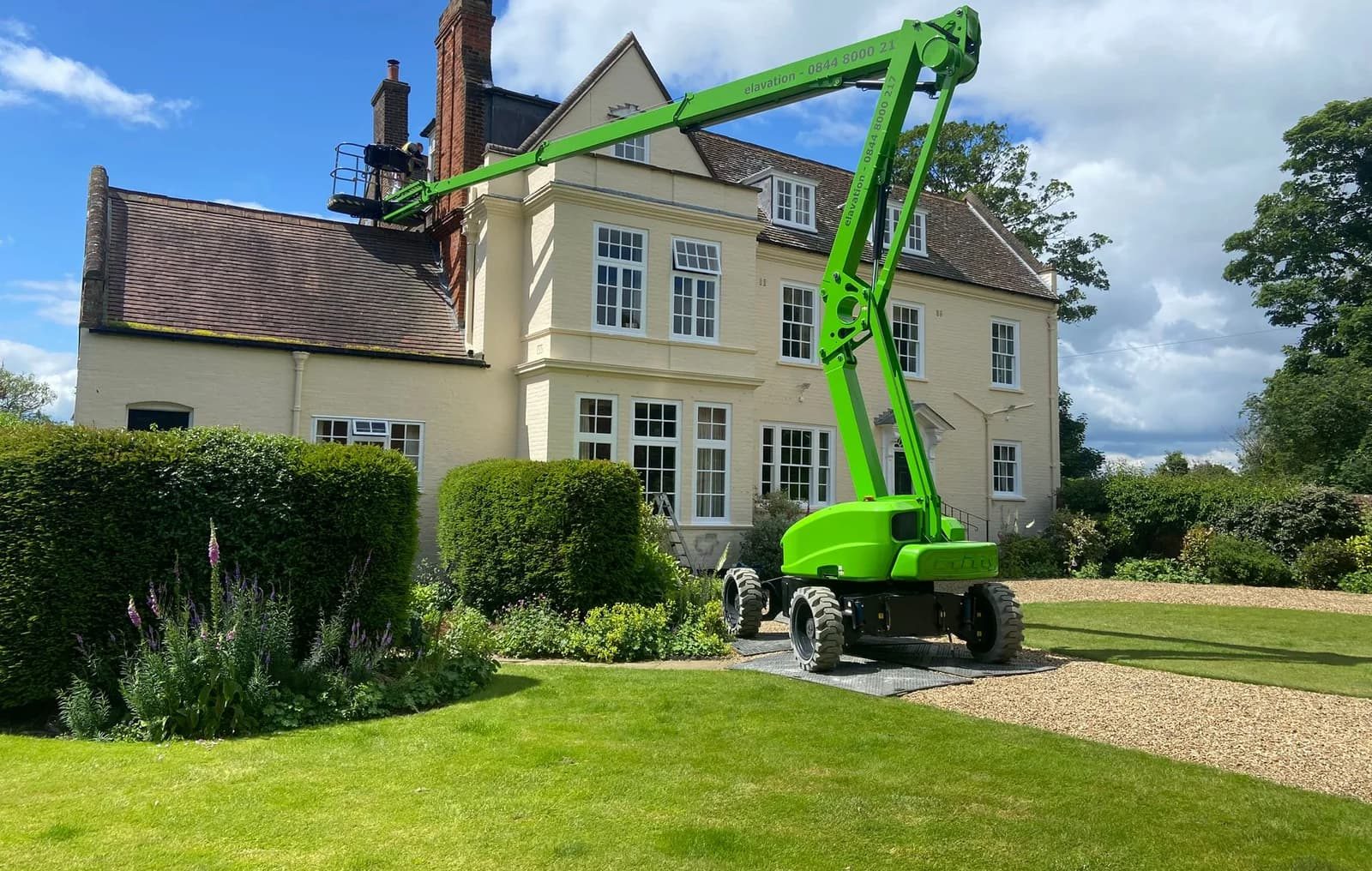 a green machine in front of a house