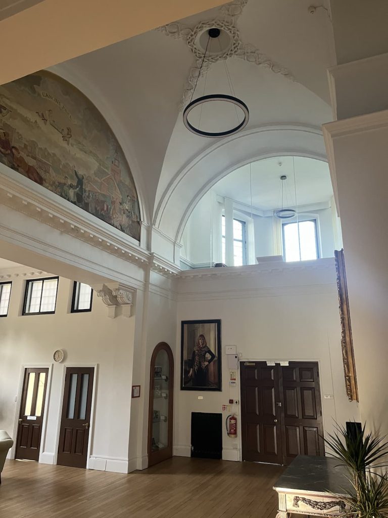 a room with a large ceiling and a large plant