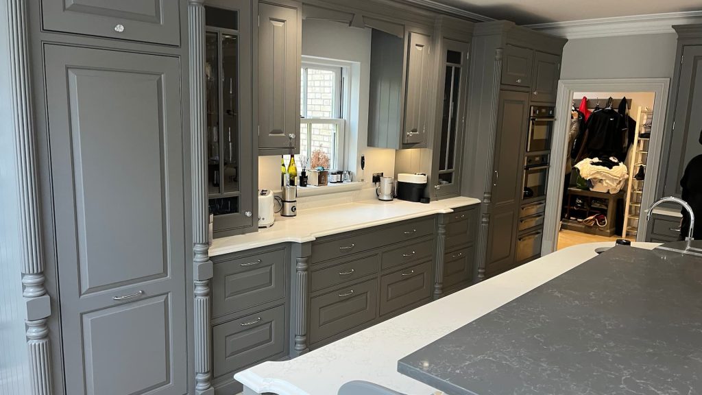 a kitchen with grey cabinets